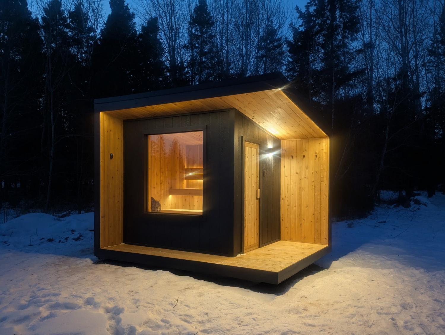 Modern sauna cabin at night in the woods