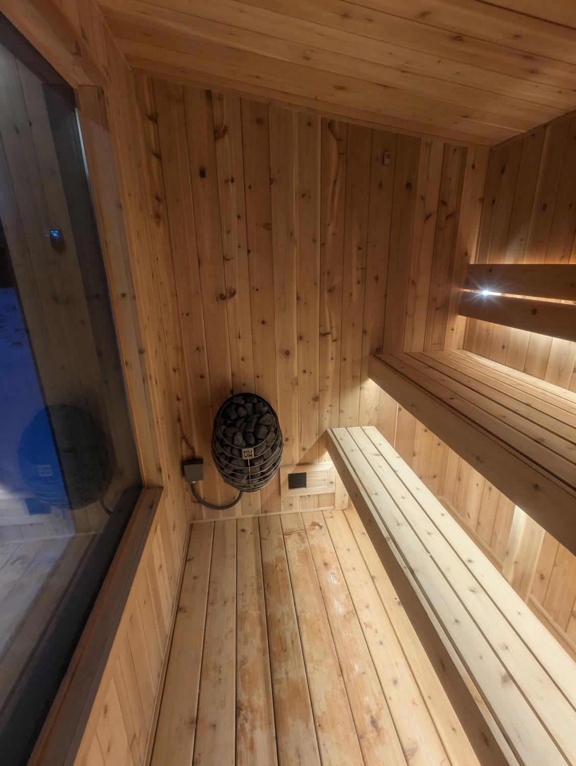 Interior of wooden sauna with heater